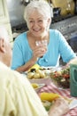 Senior Couple Eating Meal Together In Kitchen Royalty Free Stock Photo