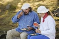 Senior couple eating outdoors in the nature Royalty Free Stock Photo