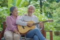 senior couple elderly man playing guitar while his wife singing together Royalty Free Stock Photo