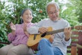 senior couple elderly man playing the guitar while his wife is singing together Royalty Free Stock Photo