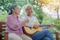 senior couple elderly man playing the guitar while his wife is singing together Royalty Free Stock Photo