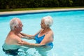 Senior couple embracing each other in the pool Royalty Free Stock Photo