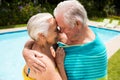 Senior couple embracing each other at poolside Royalty Free Stock Photo