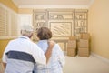 Senior Couple In Empty Room with Shelf Drawing on Wall Royalty Free Stock Photo