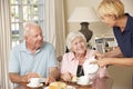 Senior Couple Enjoying Afternoon Tea Together At Home With Home Help Royalty Free Stock Photo