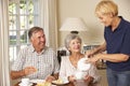 Senior Couple Enjoying Afternoon Tea Together At Home With Home Help Royalty Free Stock Photo