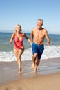 Senior Couple Enjoying Beach Holiday Royalty Free Stock Photo