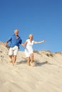 Senior Couple Enjoying Beach Holiday Running Royalty Free Stock Photo