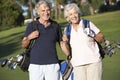 Senior Couple Enjoying Game Of Golf Royalty Free Stock Photo