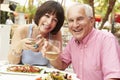 Senior Couple Enjoying Meal In Outdoor Restaurant Together Royalty Free Stock Photo