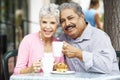 Senior Couple Enjoying Snack At Outdoor CafÃÂ½ Royalty Free Stock Photo