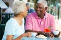 Senior Couple Enjoying Snack At Outdoor Cafe Royalty Free Stock Photo