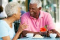 Senior Couple Enjoying Snack At Outdoor Cafe Royalty Free Stock Photo