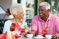 Senior Couple Enjoying Snack At Outdoor Cafe Royalty Free Stock Photo