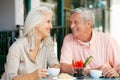 Senior Couple Enjoying Snack At Outdoor Cafe Royalty Free Stock Photo