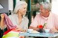 Senior Couple Enjoying Snack At Outdoor Cafe Royalty Free Stock Photo