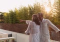 Senior couple enjoys on the terrace of a luxury house during the holidays. Selective focus Royalty Free Stock Photo