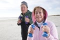 Senior couple exercising on beach Royalty Free Stock Photo