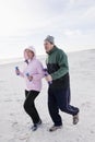 Senior couple exercising, running on beach Royalty Free Stock Photo