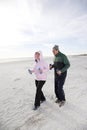 Senior couple exercising, walking on beach Royalty Free Stock Photo