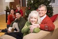 Senior couple with family by Christmas tree Royalty Free Stock Photo
