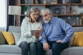 Senior couple family retired man and woman watching online consultation on video call. Two elderly patients listen a doctor or Royalty Free Stock Photo