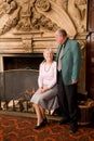 Senior couple by fireplace