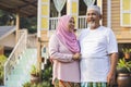 Senior couple in front of wooden house