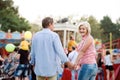 Senior couple at the fun fair, holding hands, walking. Royalty Free Stock Photo