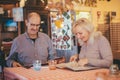 Senior couple giving a look to menu in typical Italian restaurant Royalty Free Stock Photo