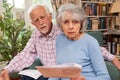 Senior Couple Going Through Finances Looking Worried Royalty Free Stock Photo