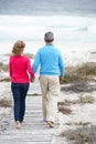 Senior couple going for romantic walk by sea Royalty Free Stock Photo