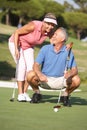 Senior Couple Golfing On Golf Course