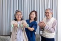 Senior couple get medical service visit from caregiver nurse at home while dumbbell exercising muscle strength in pension