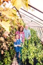 Senior couple with grandaughter gardening in the backyard garden. Royalty Free Stock Photo