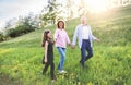 Senior couple with grandaughter outside in spring nature, walking. Royalty Free Stock Photo