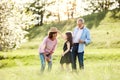 Senior couple with granddaughter outside in spring nature, having fun. Royalty Free Stock Photo