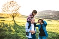 Senior couple with granddaughter outside in spring nature, having fun. Royalty Free Stock Photo