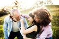 Senior couple with granddaughter outside in spring nature, having fun. Royalty Free Stock Photo