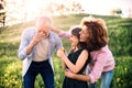 Senior couple with granddaughter outside in spring nature, having fun. Royalty Free Stock Photo