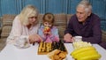 Senior couple grandfather, grandmother resting on sofa, playing chess with granddaughter child kid Royalty Free Stock Photo