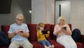 Senior couple grandparents with child girl granddaughter using digital tablet, mobile phone Royalty Free Stock Photo