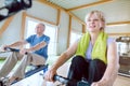Senior couple in the gym on a rowing machine Royalty Free Stock Photo