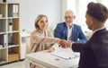 Senior couple, happy old people and realtor handshake deal in office Royalty Free Stock Photo