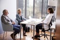 Senior Couple Having Consultation With Female Doctor In Hospital Office Royalty Free Stock Photo