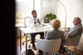 Senior Couple Having Consultation With Male Doctor In Hospital Office Royalty Free Stock Photo