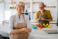 Senior couple having fun in kitchen with healthy food at home Royalty Free Stock Photo