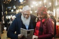 Senior couple having fun in london market at evening time - Focus on faces