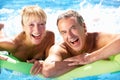 Senior Couple Having Fun In Swimming Pool Royalty Free Stock Photo