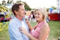 Senior couple having a good time at the fun fair Royalty Free Stock Photo